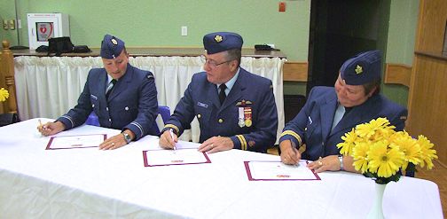 Signing the change of command documents, are Lt. Sandra Benbow (L), Captain Bob Fisher and Captain Stephanie Rutledge